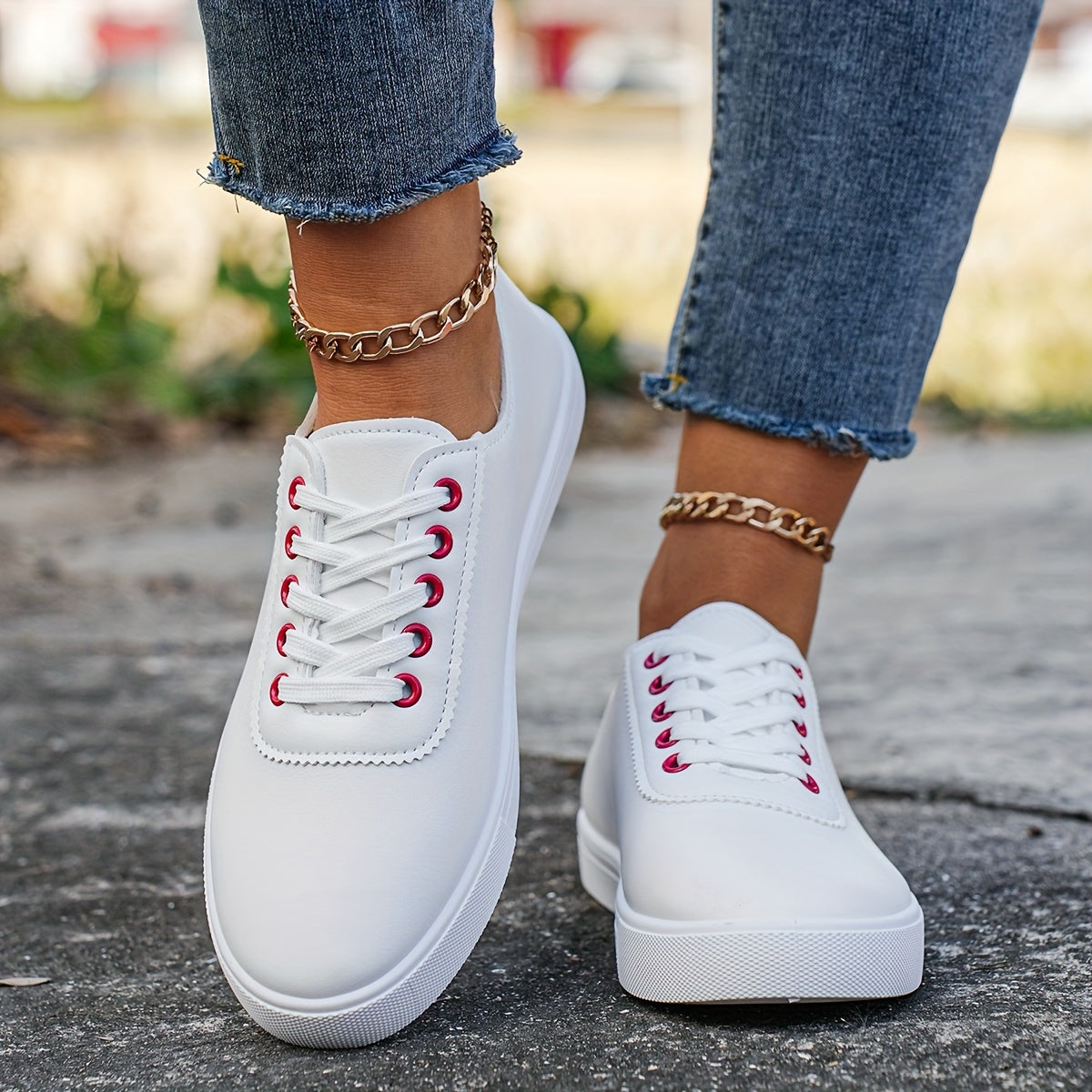 Versatile women's white sneakers with classic design, lace-up closure, round toe, and rubber sole for all seasons. Made with faux leather upper and comfortable fabric lining.