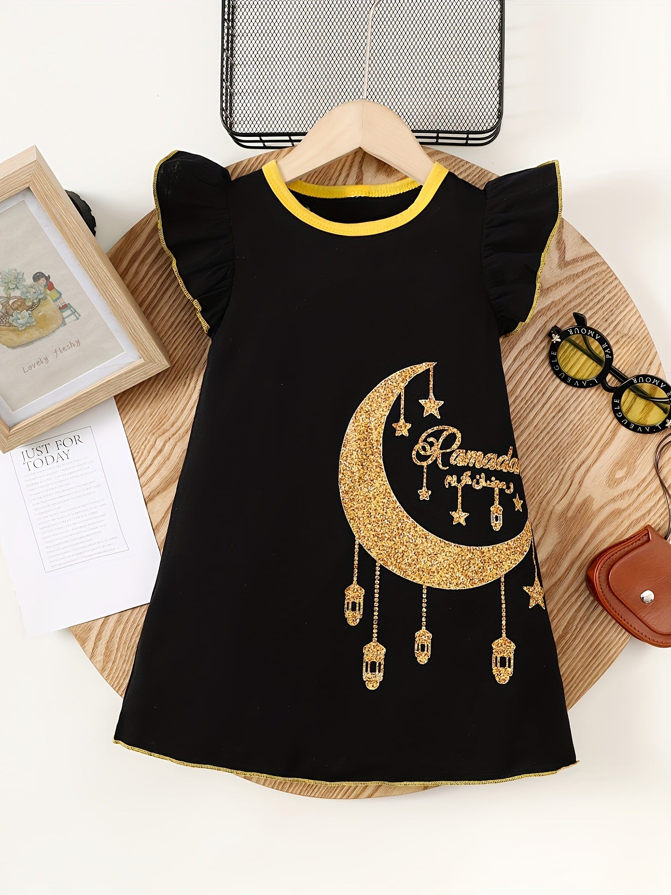 Cute sleeveless summer dress for girls featuring a cartoon girl with lanterns and moon print. Made of soft polyester with ruffled detail, in a yellow and white design suitable for casual