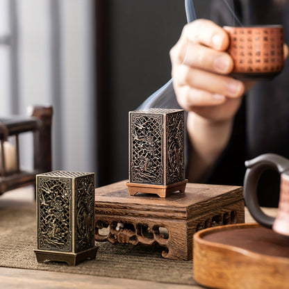 Stylish incense burner with bamboo and plum blossom design in copper/gold finish for home or office décor.