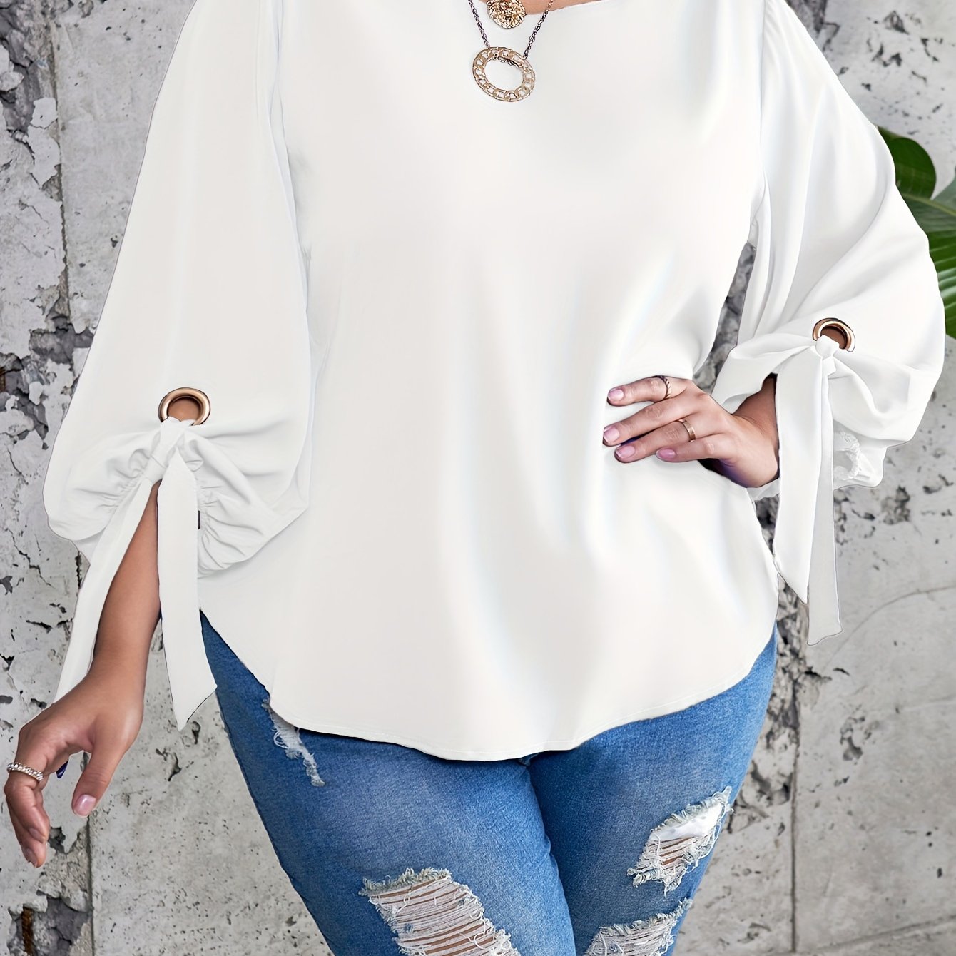 Plus size women's casual top with solid colors, lantern sleeves, round neck, round hem, and knot detail.