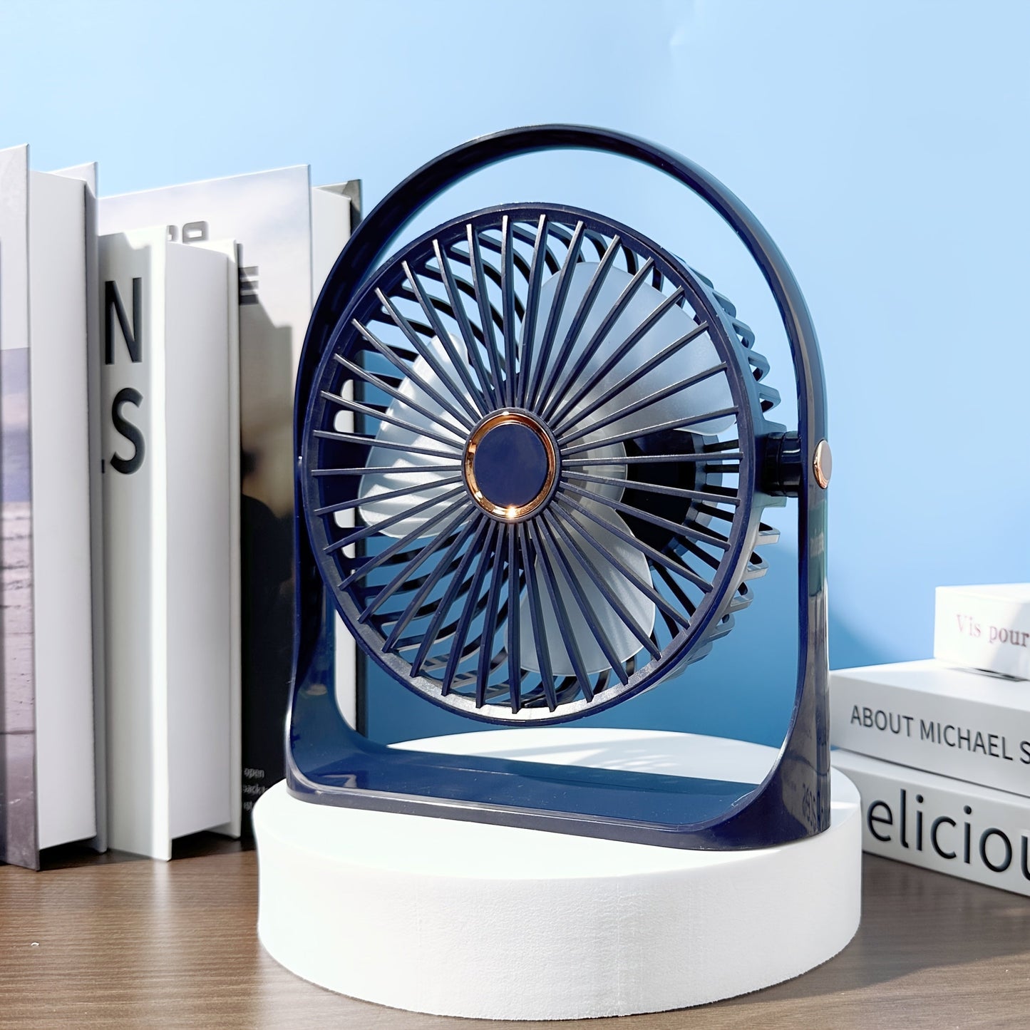 Stay cool anywhere with the JKUOO Portable USB Desk Fan. Featuring 5 speeds and 360° silent operation, this high-velocity fan is powered by a rechargeable lithium battery for indoor and outdoor use. Made of durable plastic, this table fan includes button