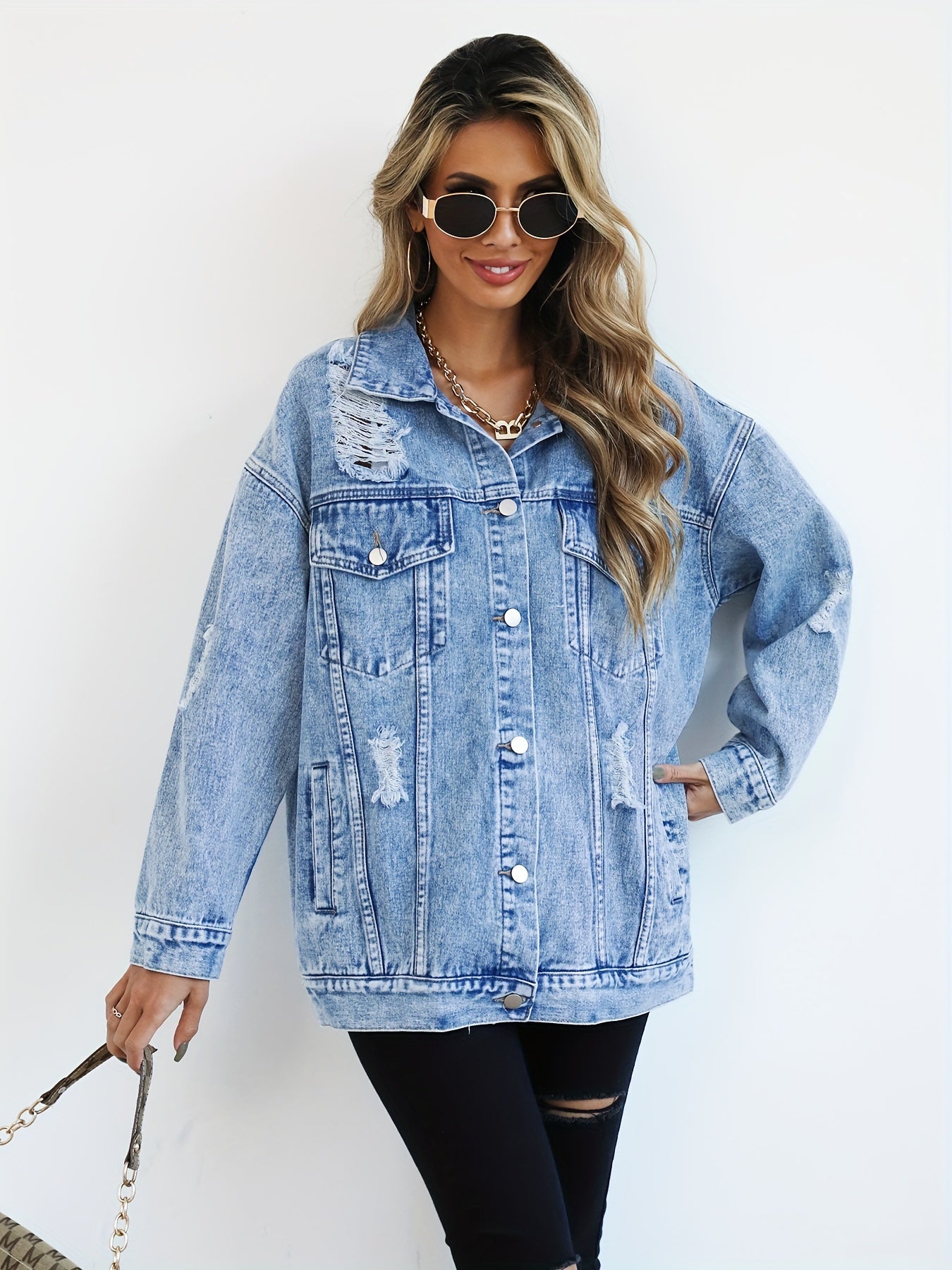 Casual light blue denim jacket for women with distressed, loose fit and ripped detailing, featuring long sleeves, flap pockets, and button closure. Made from a blend fabric and machine