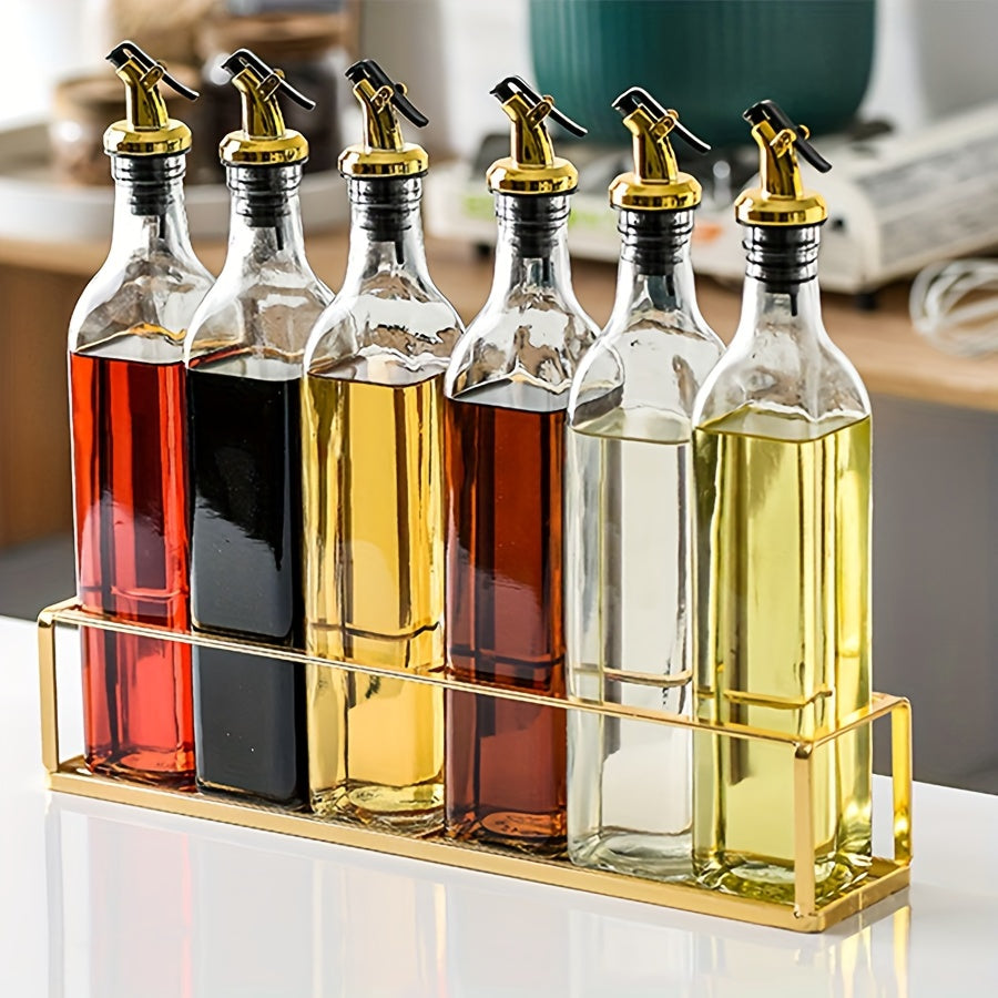 Set of glass dispenser bottles for olive oil and vinegar with a golden pour spout. Hand wash only, PVC free. Includes 6 rectangular cruets with a storage holder rack.