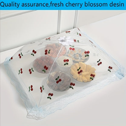 Foldable food cover with cherry design, lace trim and bow, protects against mosquitoes and dust, ideal for kitchen and dining.