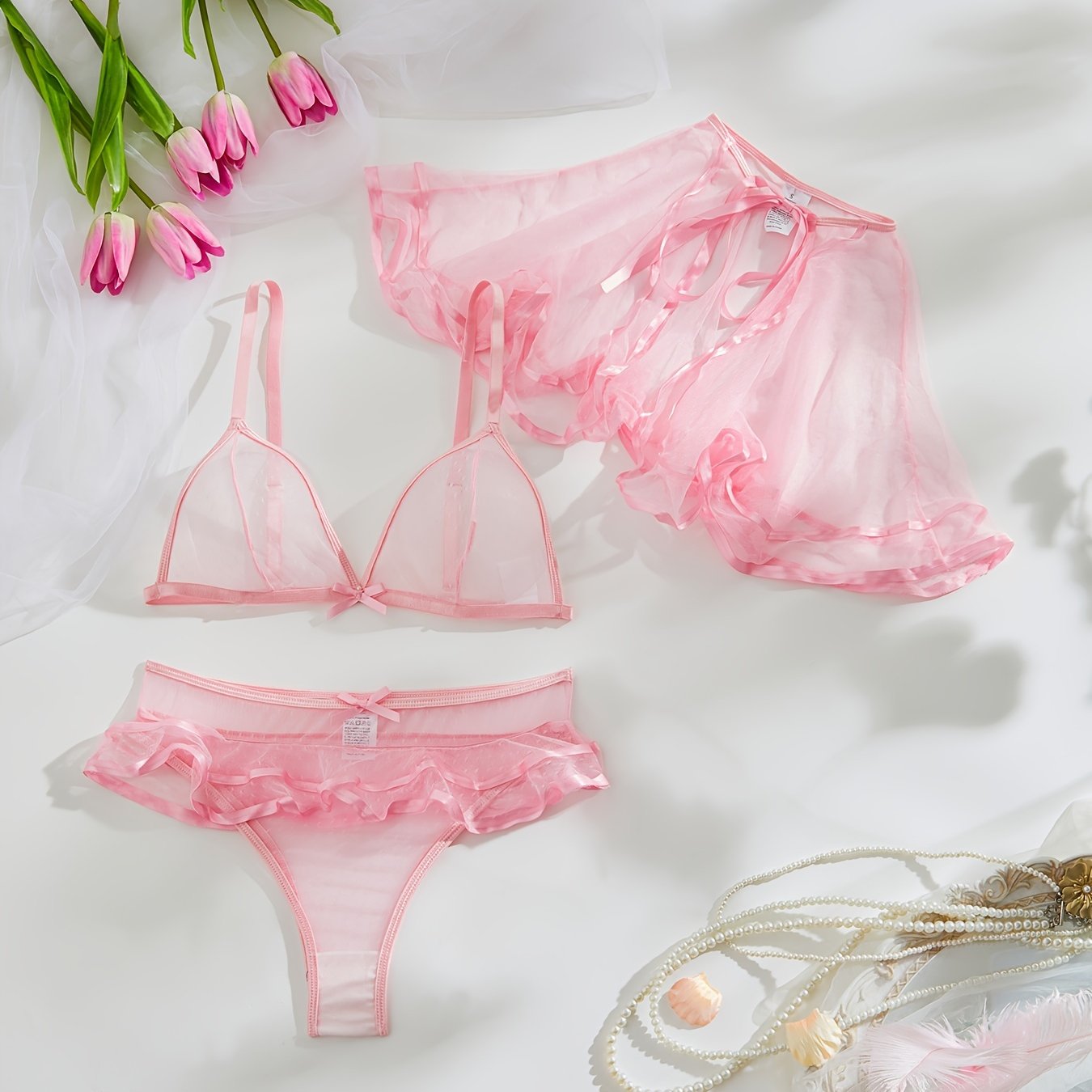 3-piece pink sheer lingerie set for women includes cape, bralette, and ruffle panty in polka dot pattern with polyamide knit fabric. Perfect for elegant bedroom roleplay.