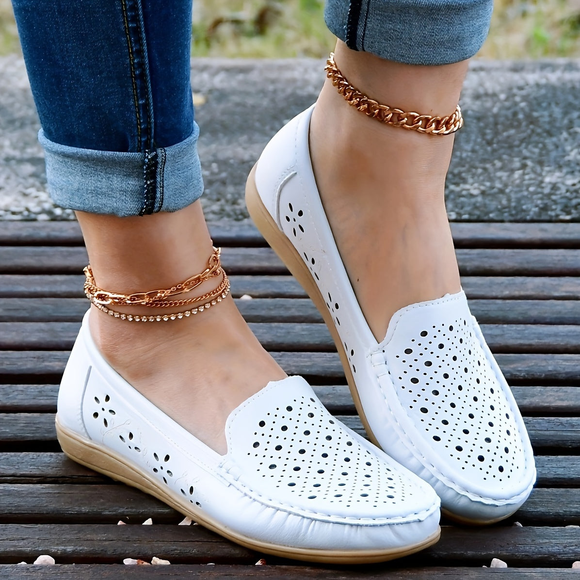 Women's white slip-on loafers with perforated design for breathability, non-slip sole, round toe, and versatile casual style for all-season wear.