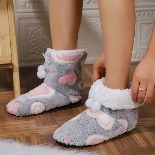 Heart-patterned slipper boots with cozy fleece lining, machine washable for indoor wear.