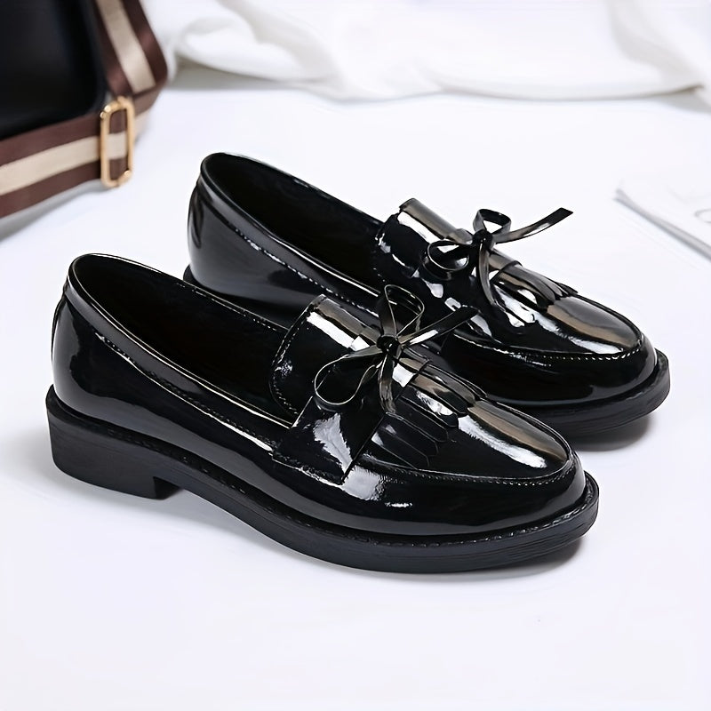 Women's slip-on shoes with preppy English style, solid color, round toe, and bow embellishment. Made of man-made materials with PVC insole and fabric inner material. Hand wash only.