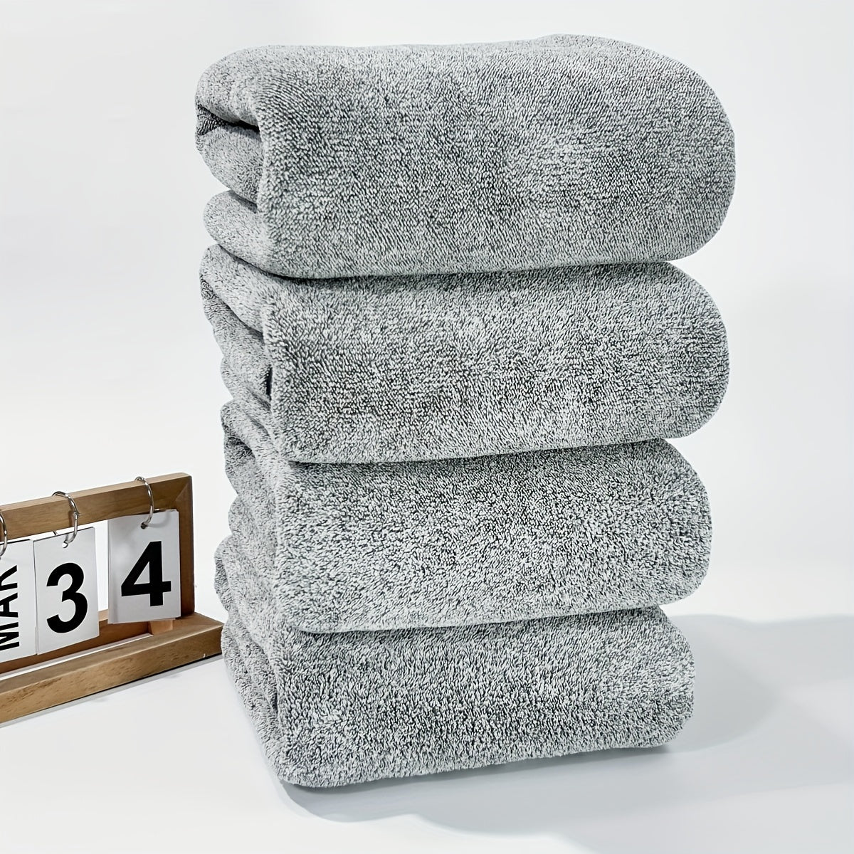 Soft coral fleece towels, 4-piece set with starry stripe design. Highly absorbent and quick-drying for bathroom use.