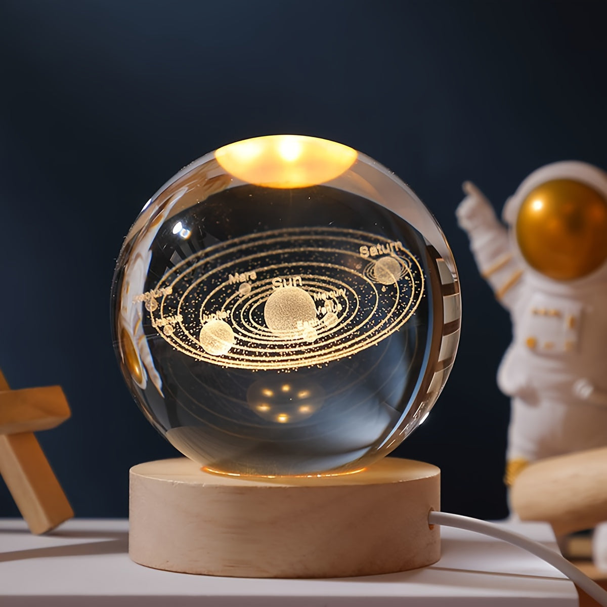 One 3D laser engraved crystal ball night light featuring the solar system and Saturn, powered by USB for home and office decoration, and makes a special gift for Valentine's Day, Christmas, or birthdays.