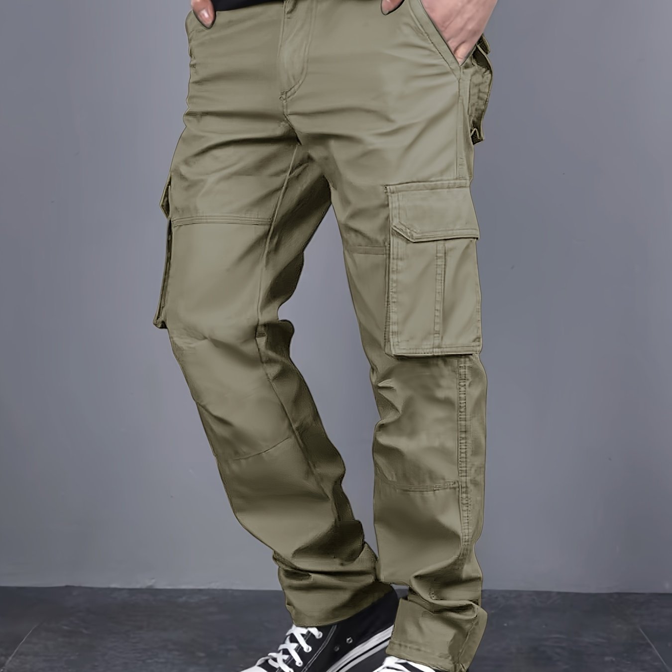 Solid color cargo pants with multiple flap pockets and a drawstring waistband, perfect for outdoor activities like hiking, fishing, and camping.