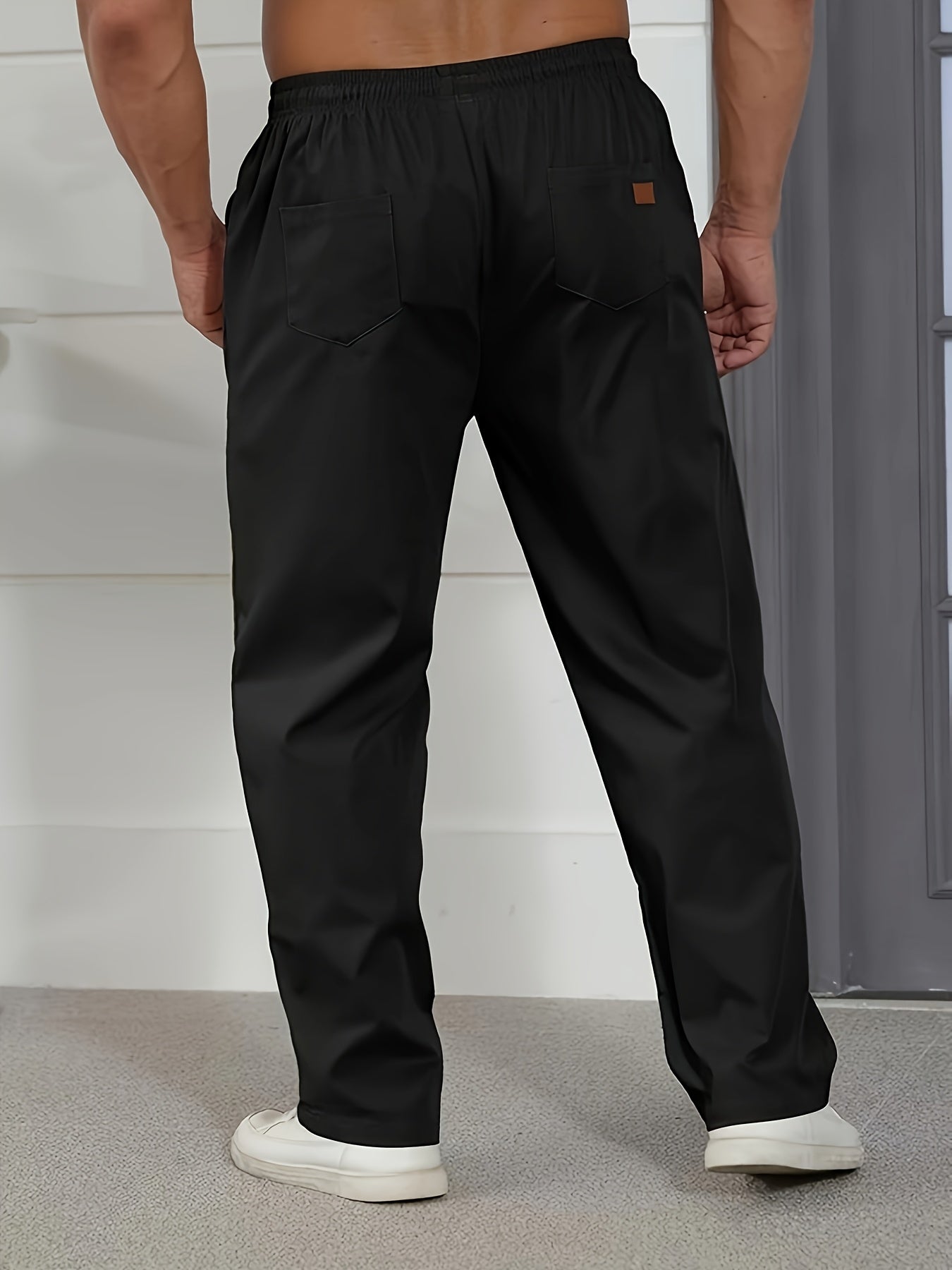 Men's slim fit casual pants with pockets, mid-rise drawstring waist, and breathable polyester fabric for spring/fall wear.