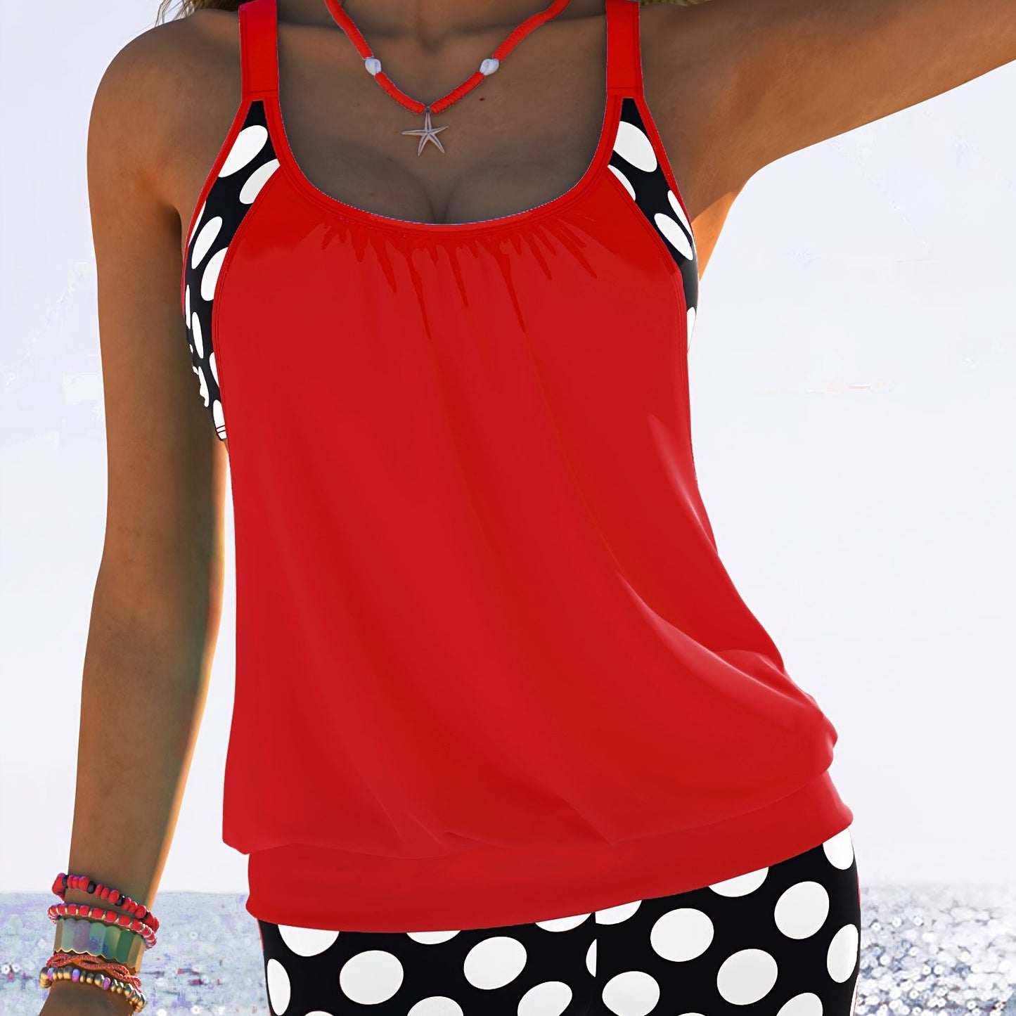 Yellow and black polka dot tankini set for women made of stretchy polyester/elastane blend. Includes round neck top with ruched design and high-waisted shorts. Machine washable. Ideal for