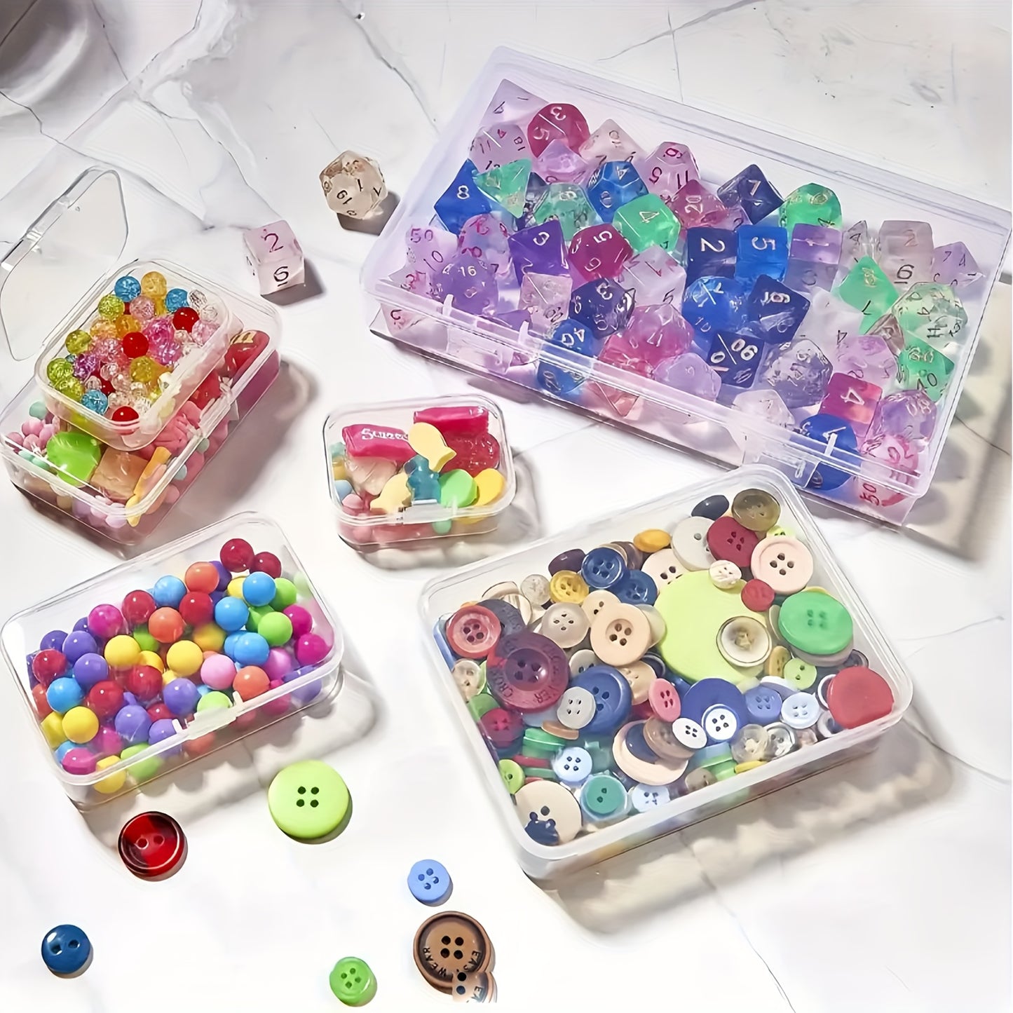 Clear plastic storage boxes with hinged lids in assorted sizes for organizing jewelry, beads, office supplies, and games.