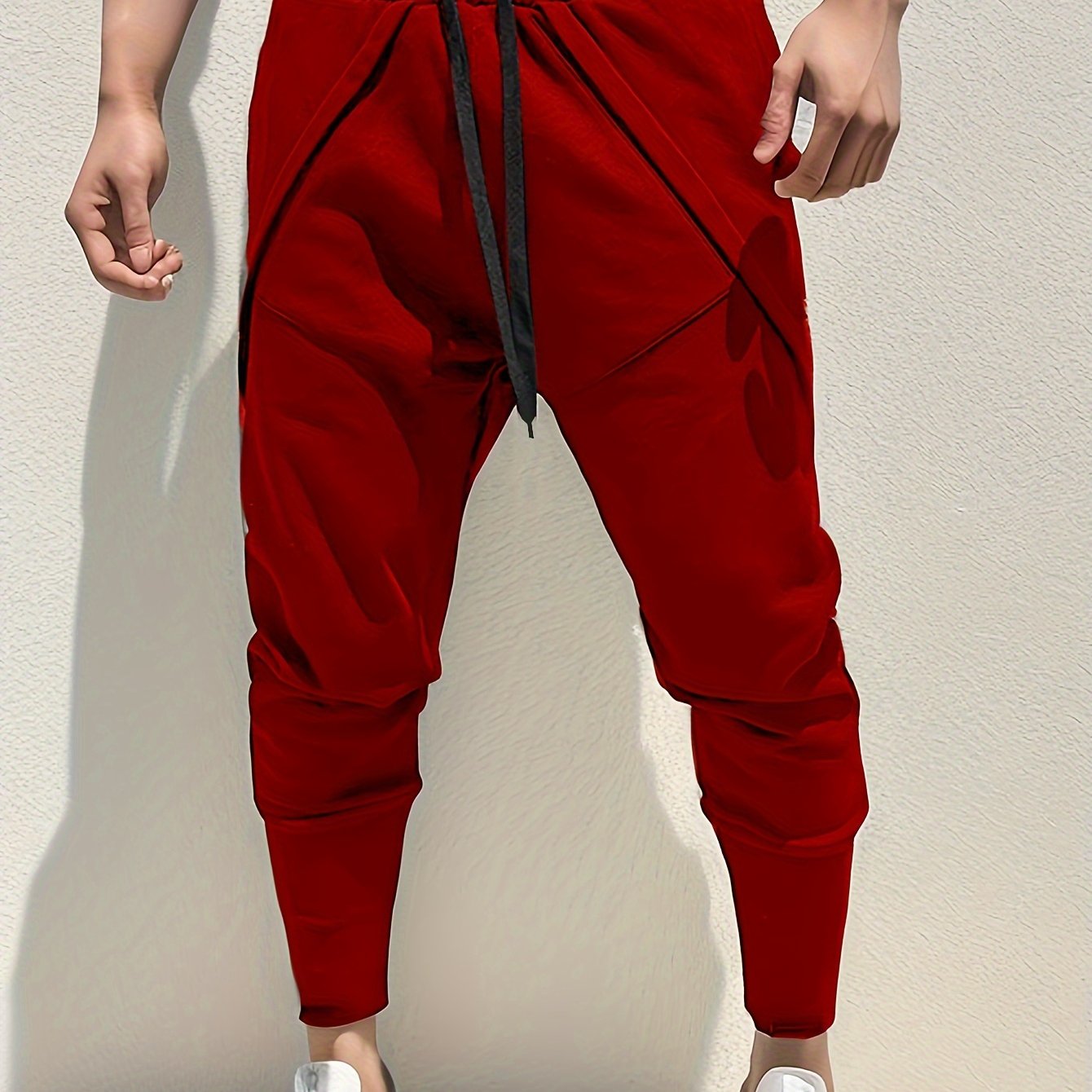 Casual style men's athletic sweatpants with tapered fit, side pockets, and adjustable drawstring for sports and relaxation.