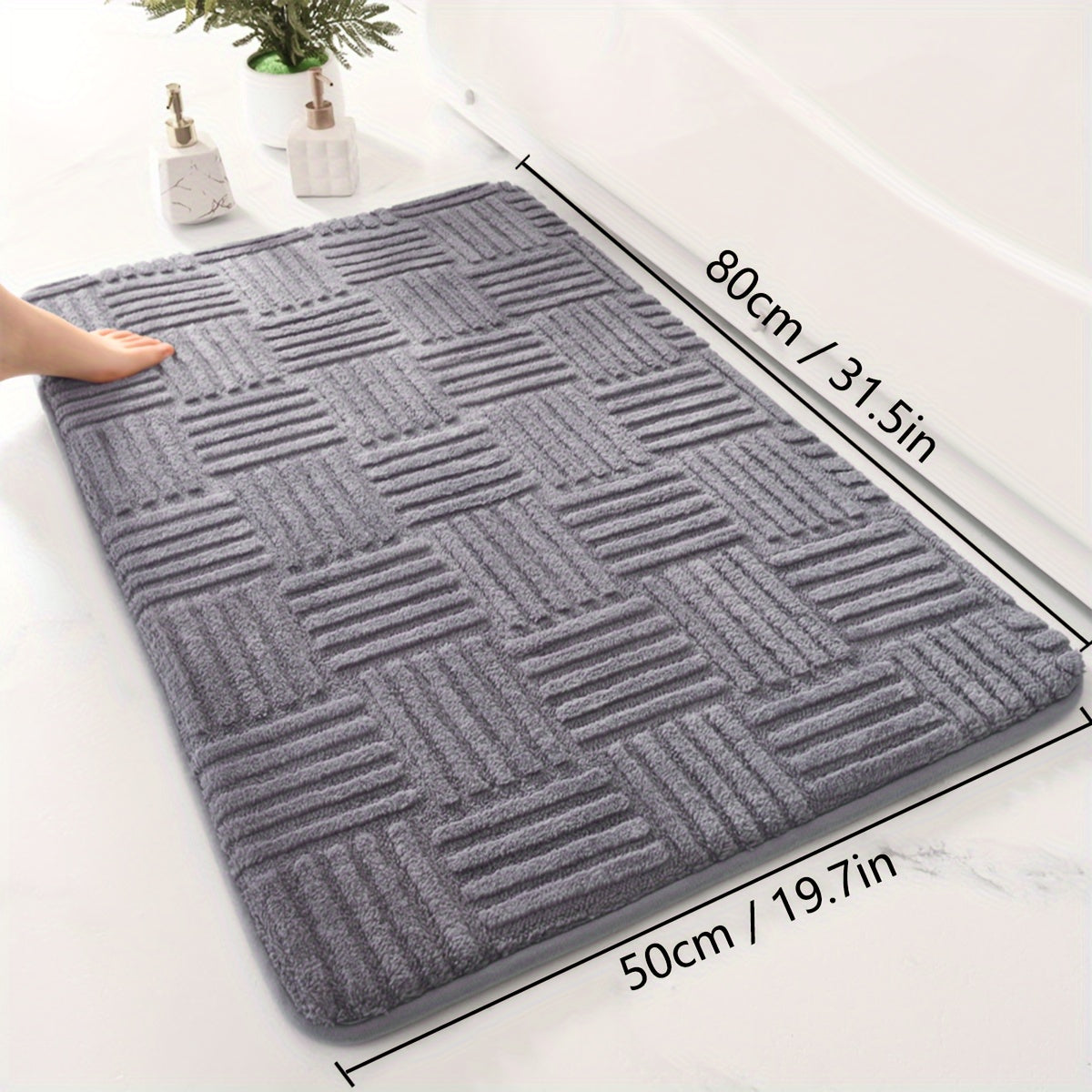 One piece of a thickened bathroom absorbent mat with a non-slip bathtub rug. Can also be used as a home entryway carpet with a solid color and stripe pattern. The mat is rectangular in shape and lightweight, machine-made with a PVC backing. Made of