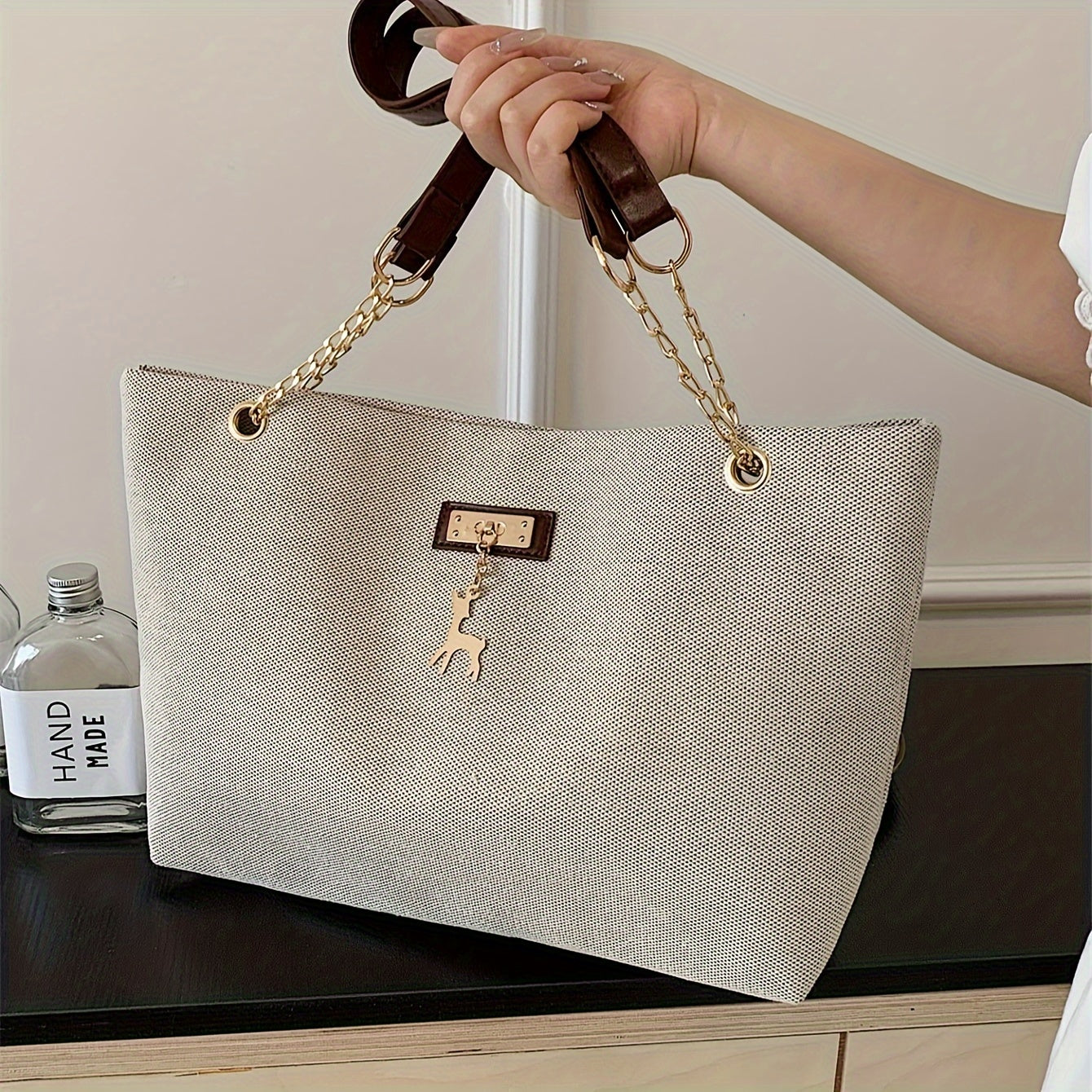 Polyester tote bag for women with deer charm, adjustable strap, zipper closure, painted edges, and messenger bag style.