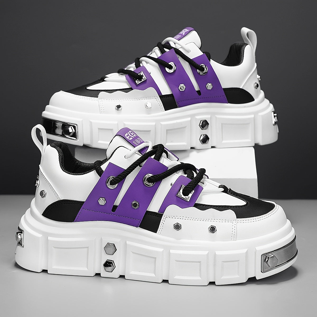 Chunky, punk-inspired sneakers with metal stud accents. Streetwear fashion statement in white, thick-soled trainers. Ideal for skateboarding, parties, and everyday wear. Unisex.