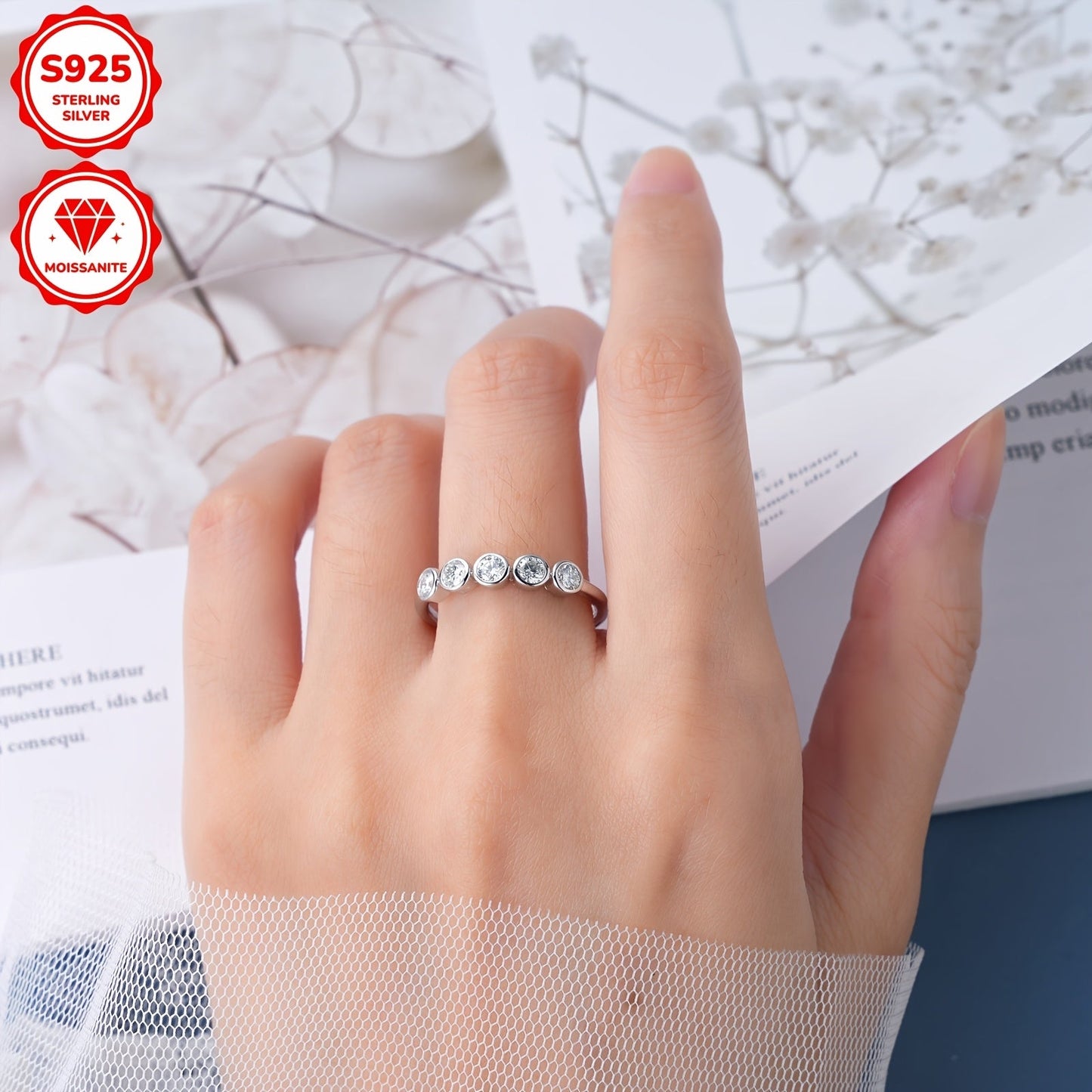 This women's engagement ring is made of 925 silver and boasts a dazzling five-stone Moissanite design, showcasing a 3mm round Moissanite stone at its center. The ring weighs 1.95 grams and is adorned with five additional 3mm Moissanite stones, totaling