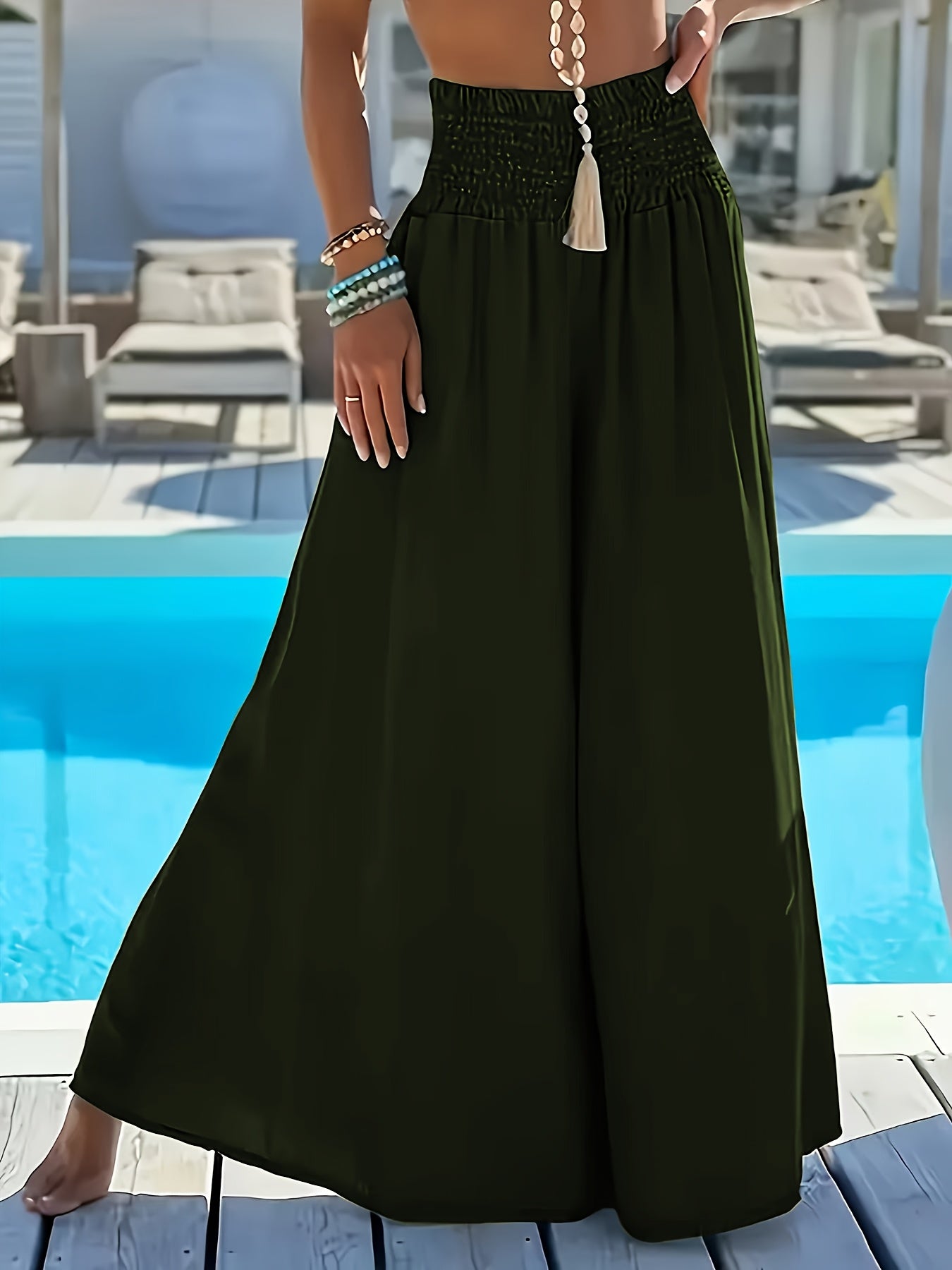 Plus size women's high-waisted wide leg pants in solid green polyester with tassel detail, perfect for comfortable casual outings.