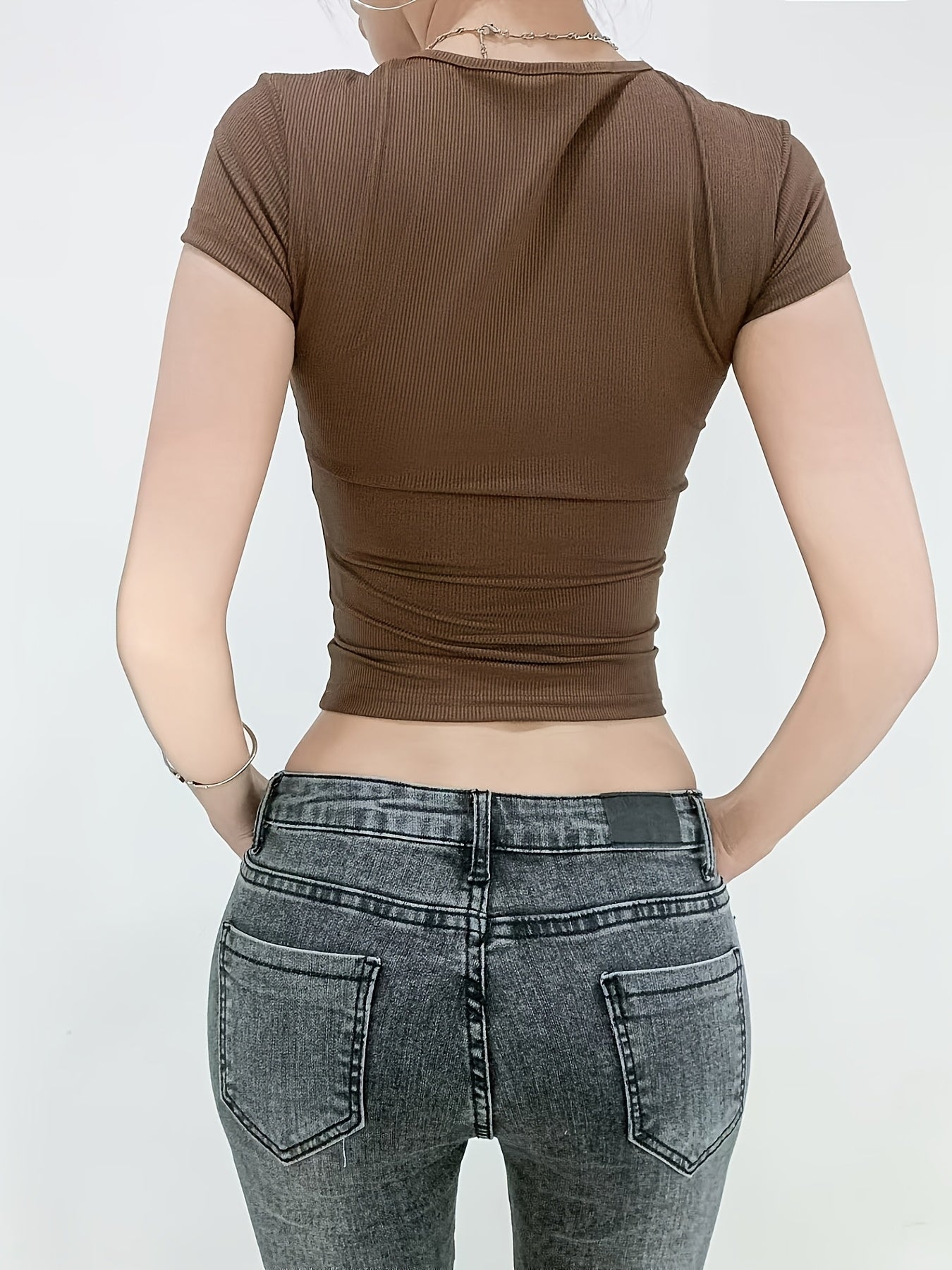 Women's ribbed short-sleeve t-shirt made of high elastic polyester and spandex blend. Features a round neck, slim fit, cropped length, and solid color. Perfect for a casual and sexy style