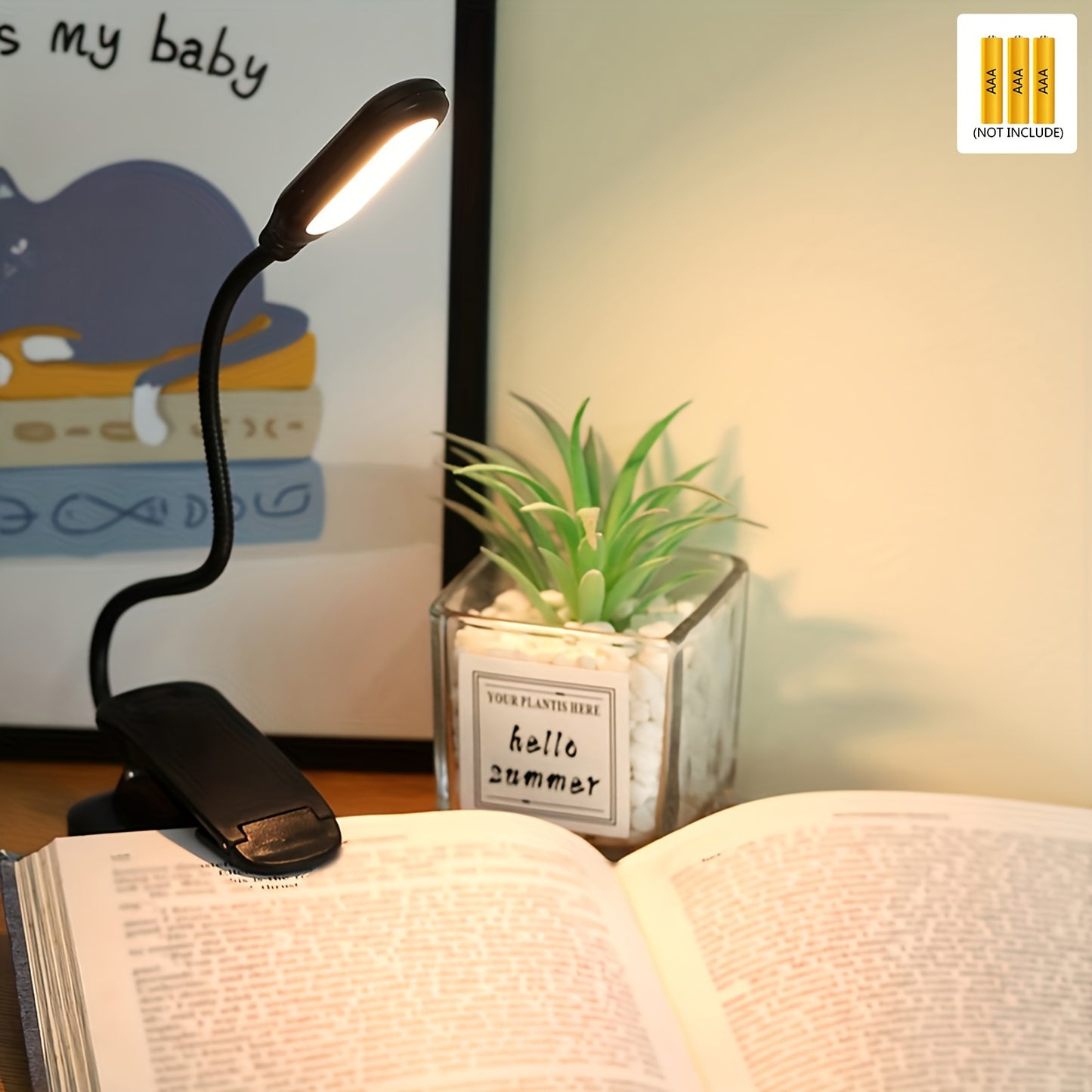 Portable battery-powered space-themed book light with adjustable arm, push button control, and uplight lighting, ideal for bedside use.