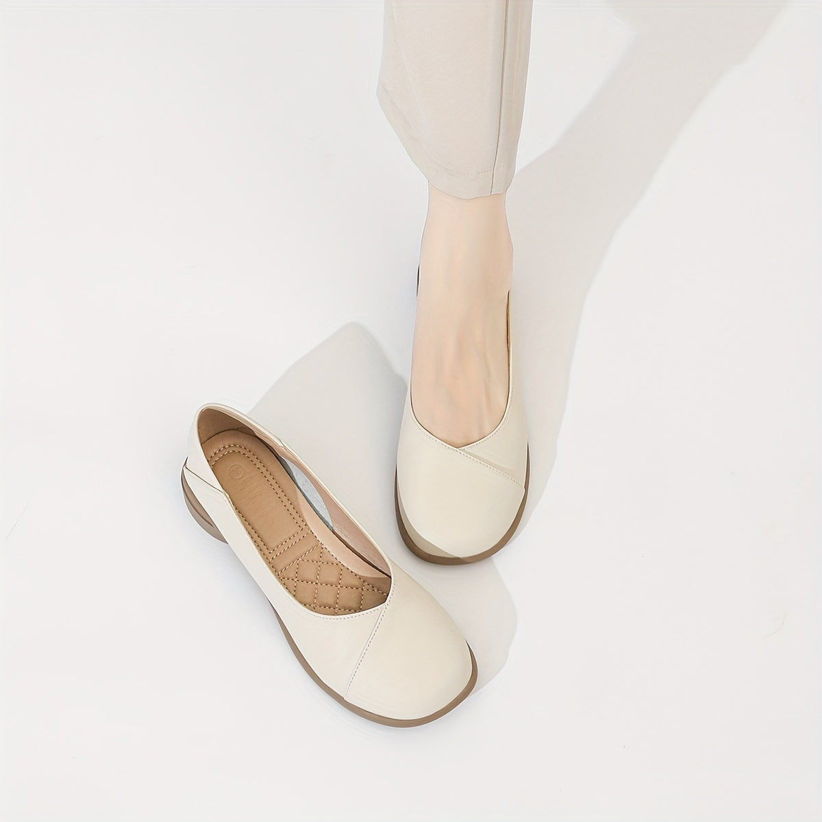 Stylish white low heel flats with all-day comfort for work.