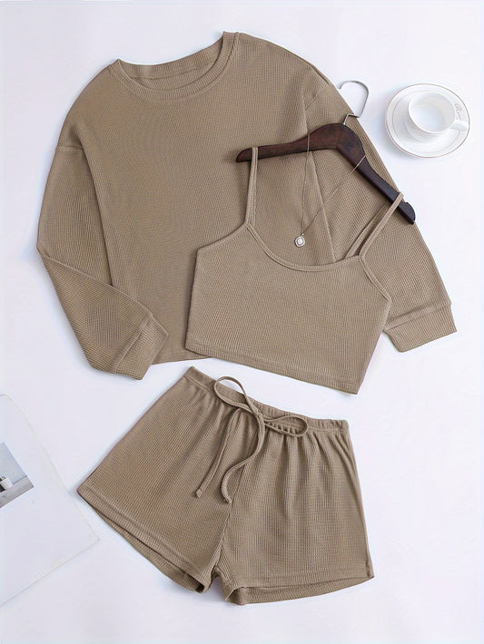 Women's loungewear set with waffle texture, long sleeve top, crop cami, and elastic shorts.