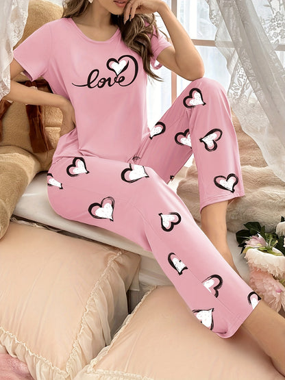 Stylish pink heart print pajama set for women with comfy short sleeve top and long pants, made of breathable polyester blend fabric.