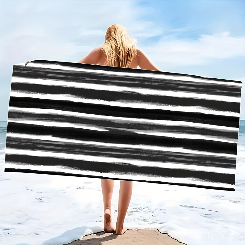 Oversized striped beach towel perfect for adventures. Made of super soft microfiber, quick-dry, sand-free, and ideal for various activities. Available in tropical blue & white. Comes in two sizes and is lightweight and absorbent.