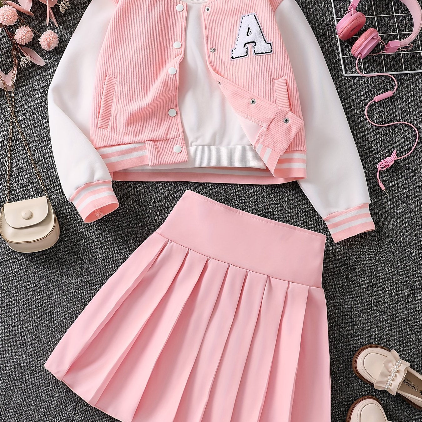 Set of 2 includes a baseball jacket with embroidered letters and a pleated skirt.