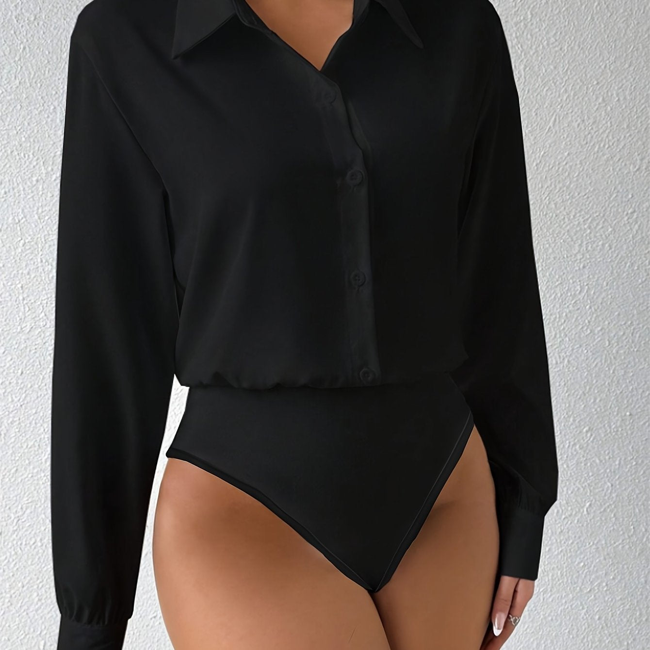 Elegant solid color collared bodysuit for women with button front and long sleeves.