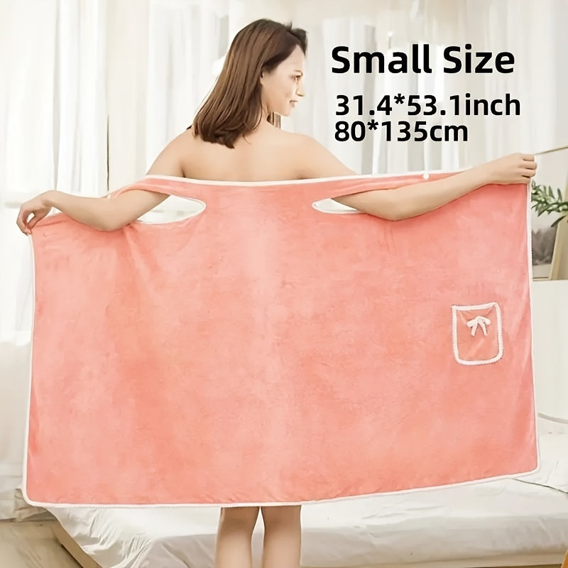 Soft coral velvet wearable bath towel with bow detail, ideal for bathroom and beach use. Thich, absorbent, quick-dry, pink with white border. Durable woven texture. Perfect for everyday comfort.