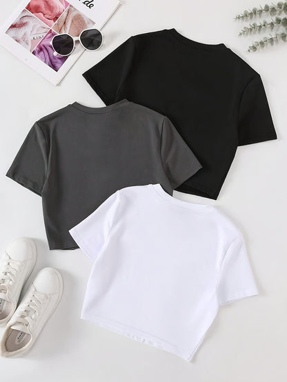 Three women's slim fit crop tops in black, white, and dark gray. Made of polyester and machine washable. Great for layering.