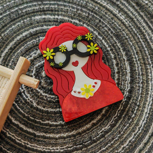 Vintage acrylic brooch pin featuring a unique irregular shape, adorned with a cartoon-themed floral glasses girl design. This decorative accessory is perfect for adding a fashionable touch to any outfit. Mix and match with clothing for a stylish look.