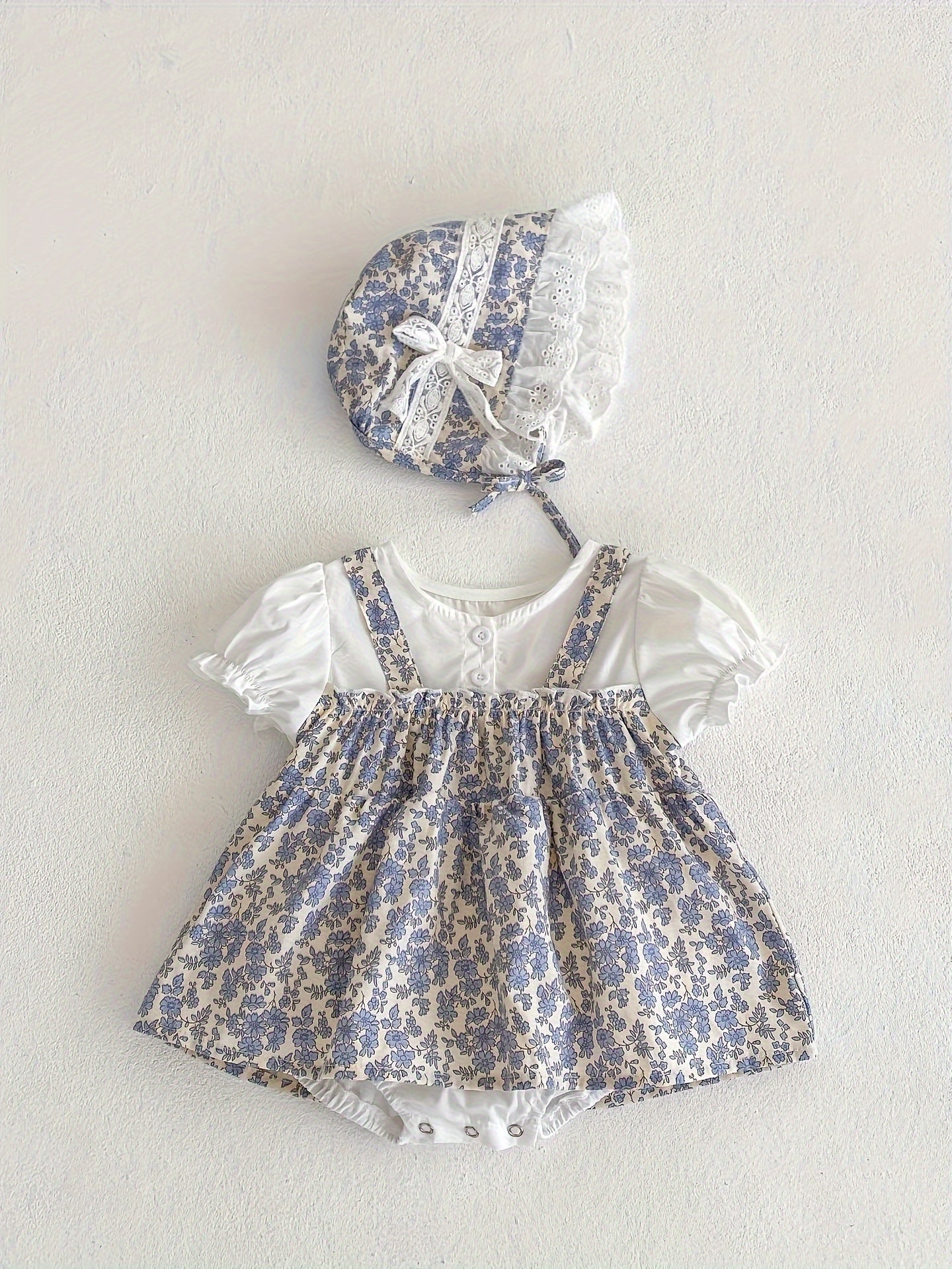 Baby's floral pattern romper dress with puff sleeves and matching hat, perfect for outdoor wear for toddler and infant girls.