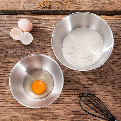 Set of 3 stainless steel mixing bowls with measurement marks, ideal for cooking and baking in kitchens and restaurants.