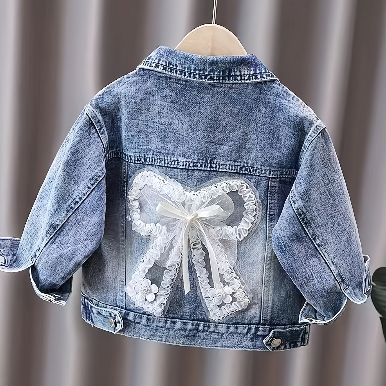 Children's loose fit denim jacket for girls, made from soft fabric.