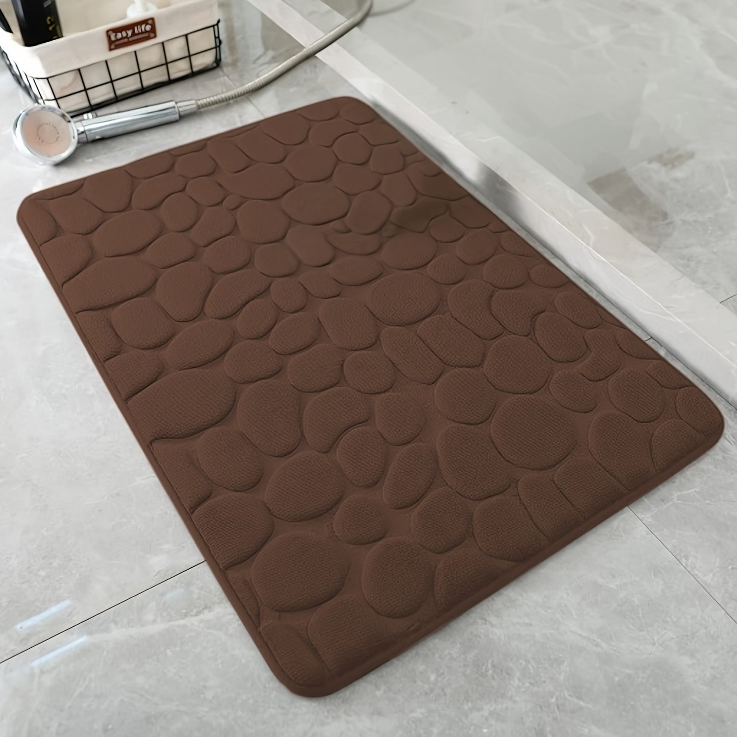 Pebble pattern bath mat in blue winter wonderland design. Non-slip, absorbent, machine washable, and fluffy.