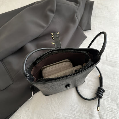 Elegant women's crossbody bucket bag with vintage style, adjustable strap, zipper closure, polyester lined. Available in black, white, dark brown, light brown. Suitable for work, commute