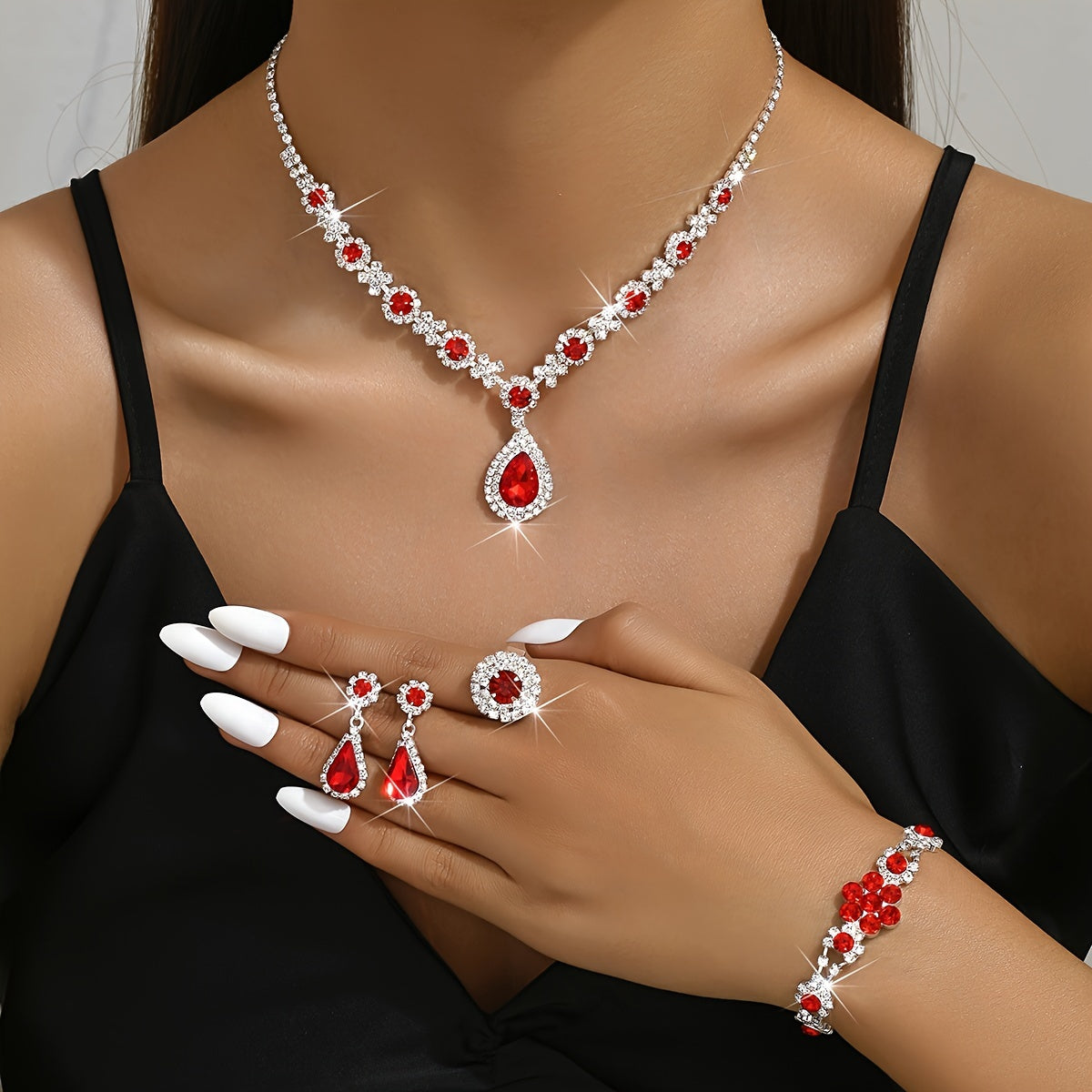 This jewelry set features a vintage 4-piece design with synthetic gemstones, a sexy tear-drop style, and a silver plated finish with rhinestones. Made from copper, this set is perfect for vacation and wedding events, and makes an ideal gift for