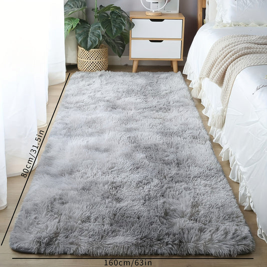 Soft and cozy shaggy area rug perfect for bedroom or living room decor. This plush light gray rug measures 160.02cm x 80.01cm and features a rectangular tie-dye design. Made of machine-washable polyester, this rug is ideal for dorm rooms and homes. Add a