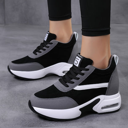 Chunky lace-up sneakers with air cushion for outdoor walks feature hidden heel for added fashion.