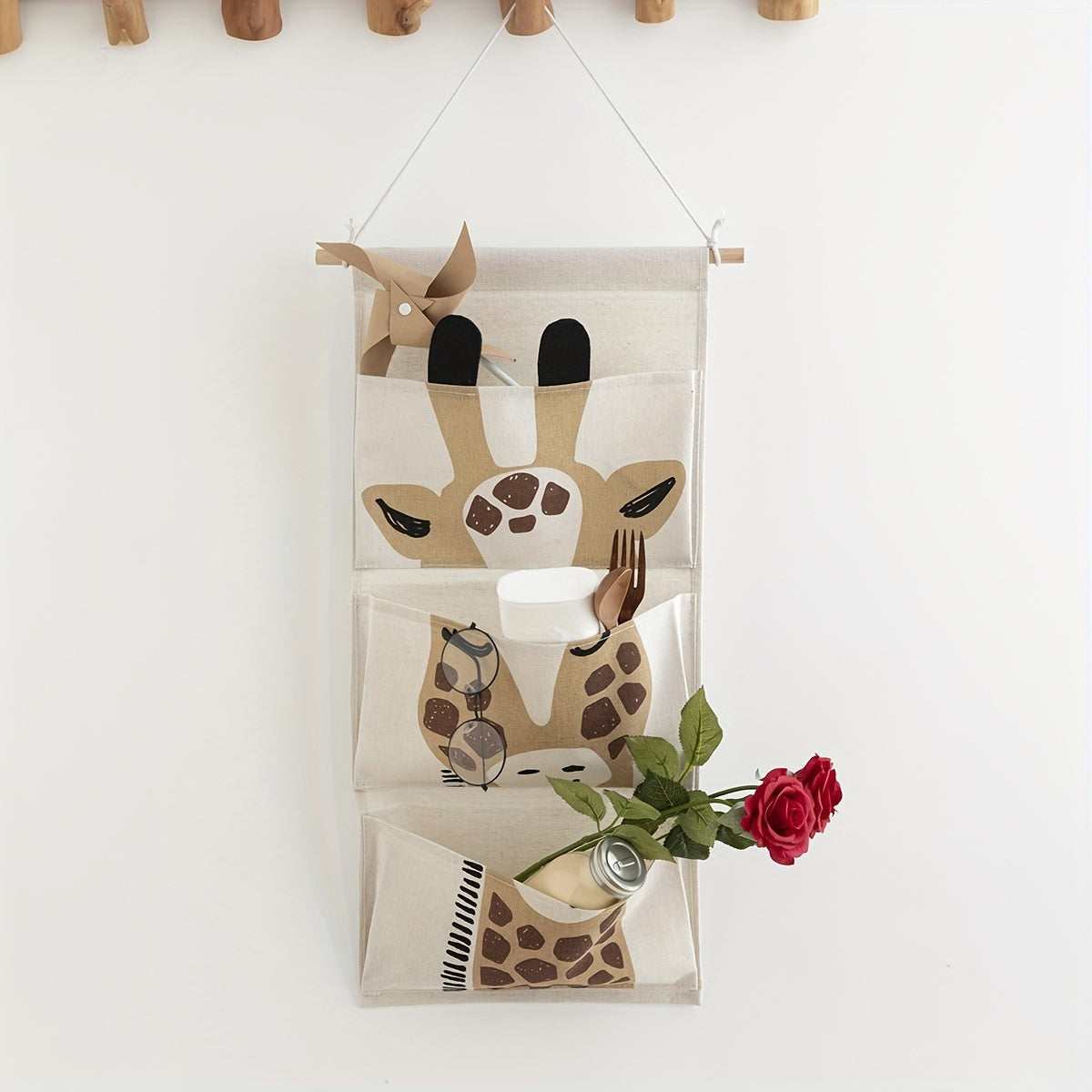 Fabric giraffe-design wall hanging storage organizer with 3 pockets, can be mounted over a door for waterproof linen closet pouch in bedroom, bathroom, or other rooms.