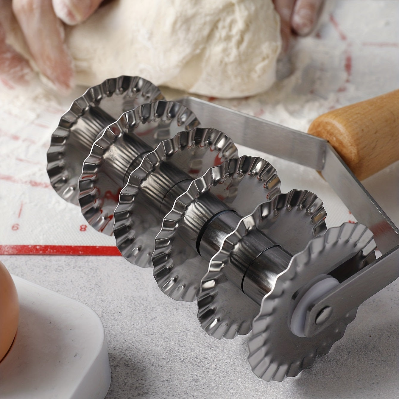 Six-wheel stainless steel cookie and noodle cutter with a wavy wood handle - Perfect for cutting cookies and noodles in the kitchen.