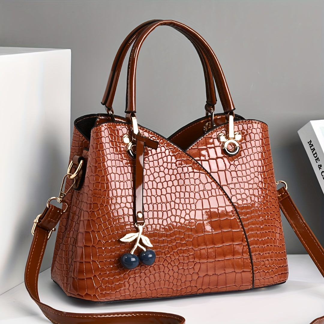 Stylish crocodile embossed tote bag with cherry pendant.