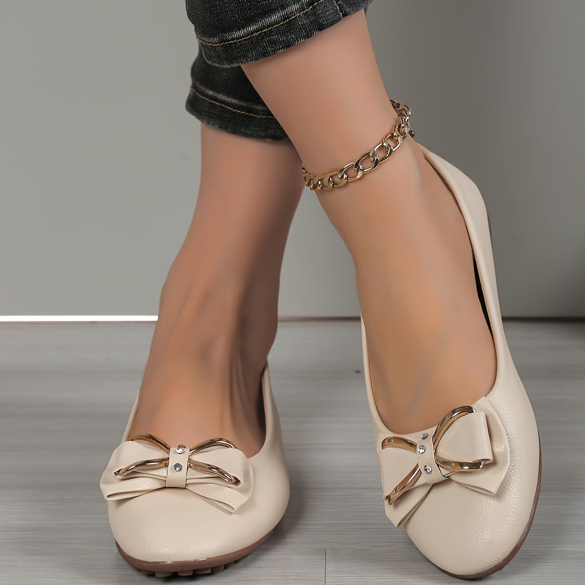 Casual flats for women with bow and rhinestone detail, round toe comfort, slip-on style, solid color.