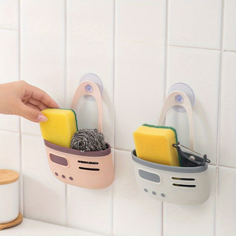 Sink basket with double-layer suction cups, made of plastic for kitchen storage. Hangs on the drain for organization without the need for wood or power. Ideal for use in home kitchens.