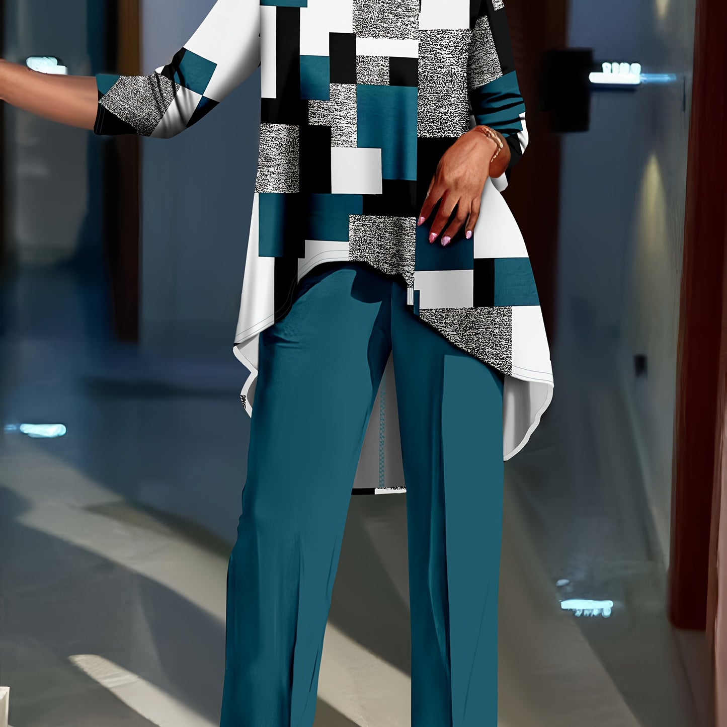 Geometric print top with long sleeves paired with solid color pants set for plus-size women.