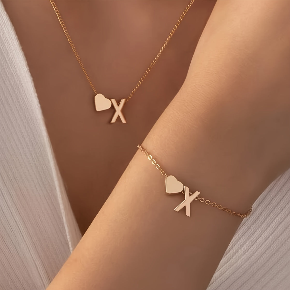 Chic two-piece set with metal heart and letter necklace and bracelet, ideal for daily wear.